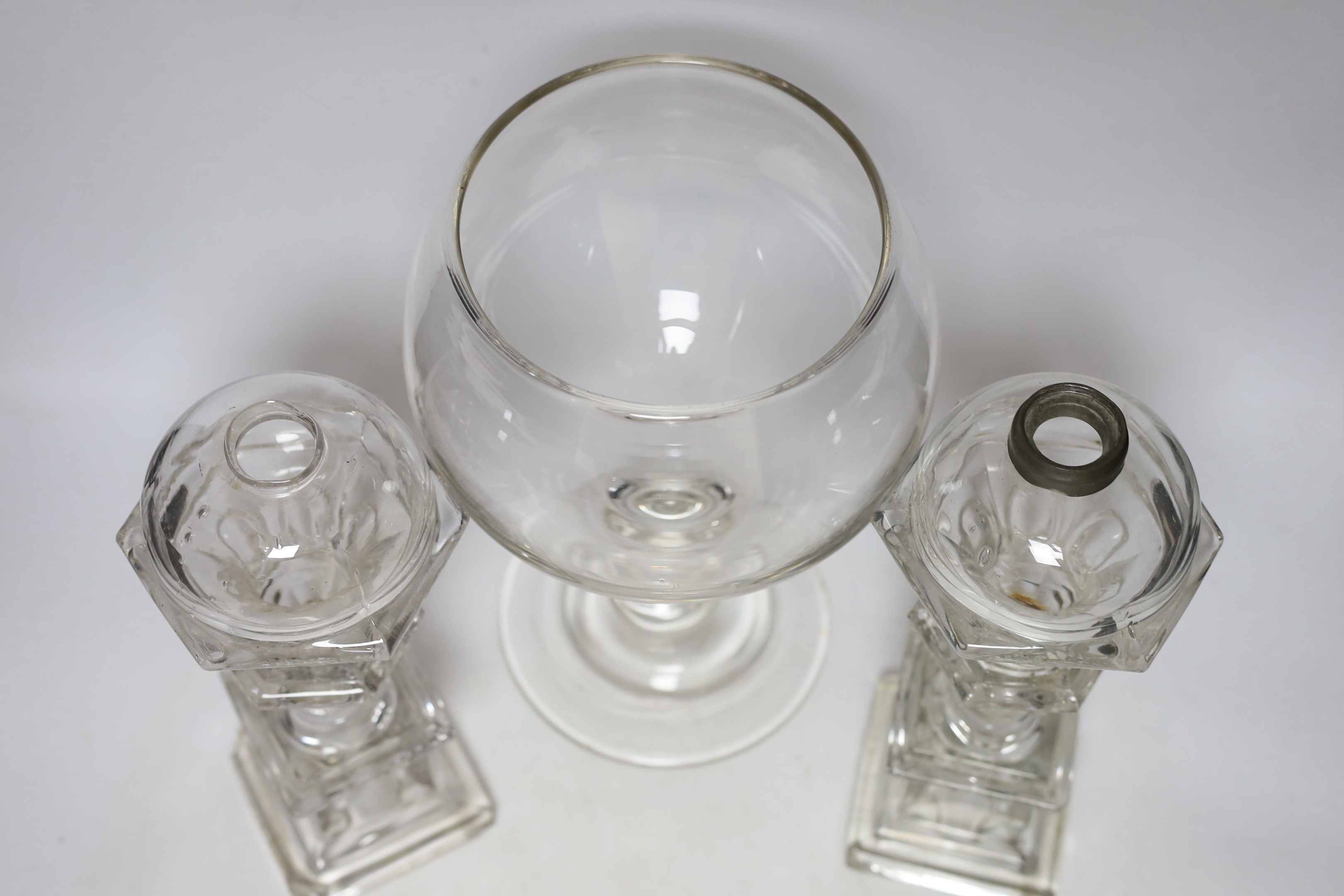 A pair of Victorian glass lamp bases and a goblet vase, largest 30cm